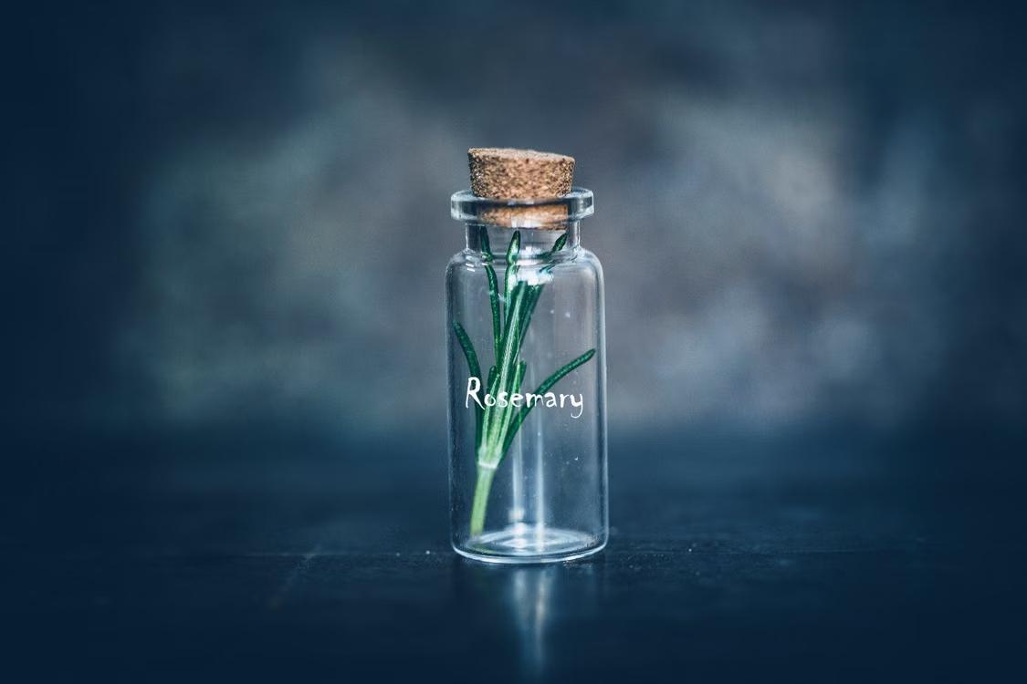 A small bit of rosemary leaf placed in the bottle. 