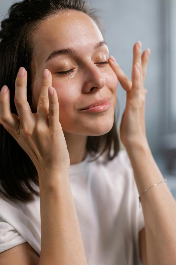 A person applying face cream A person applying face cream