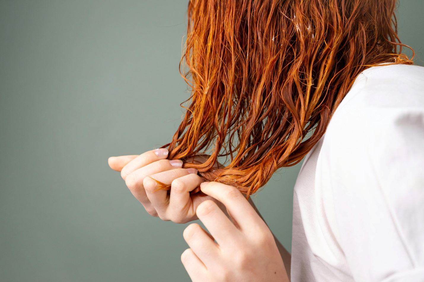 A person applying hair conditioner