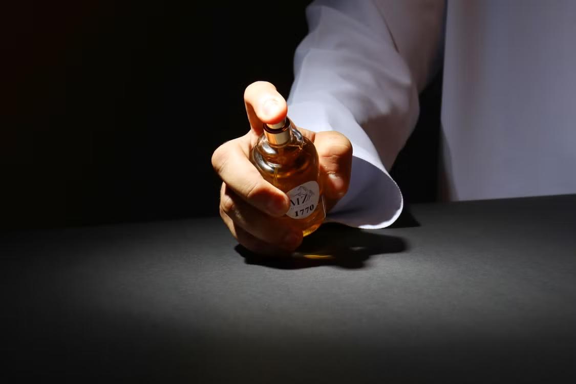A person sprinkling perfume. 